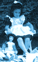 [It's a little girl playing with her doll.]