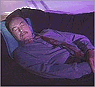 [This is a picture of a guy catching some Z's.  He looks like he's in heaven.]