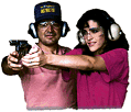 [We all need a helping hand.  And this nice young man is teaching this nice young woman to fire a high powered handgun.  We all need friends like this.  What you can't see is the target.  They would be shooting at me as I am trying to leave their apartment with a vcr.  It was my cousins.  Really.]