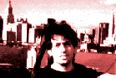 [This is a picture of a guy standing in front of the New York skyline. I haven't been to NYC in years, so I'm not 100% sure it's NYC. It could be Chicago or Tokyo.]