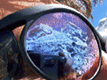 [A photo of Mt. Everest reflected on a pair of sunglasses.]